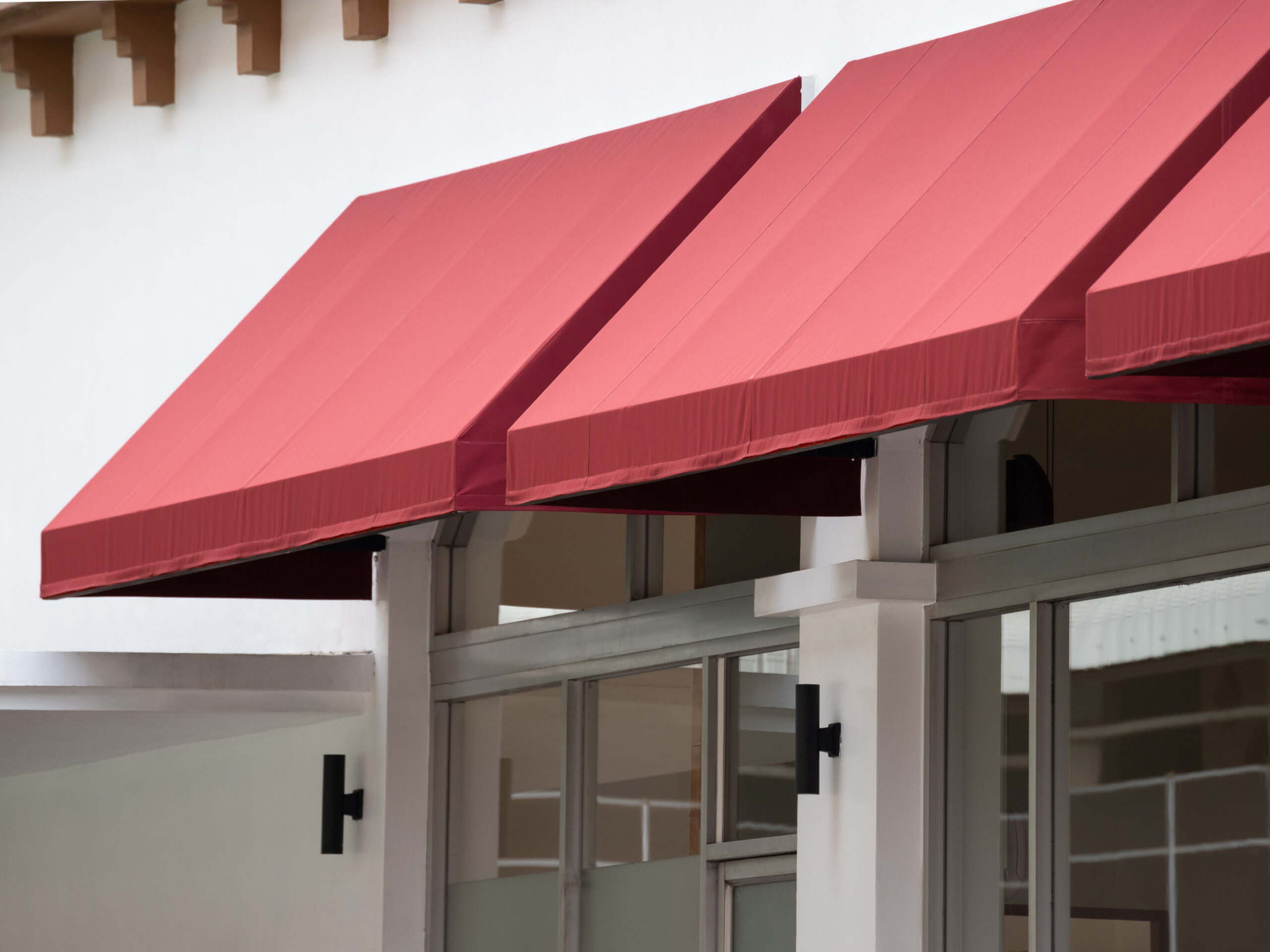 red awning over window of shop.