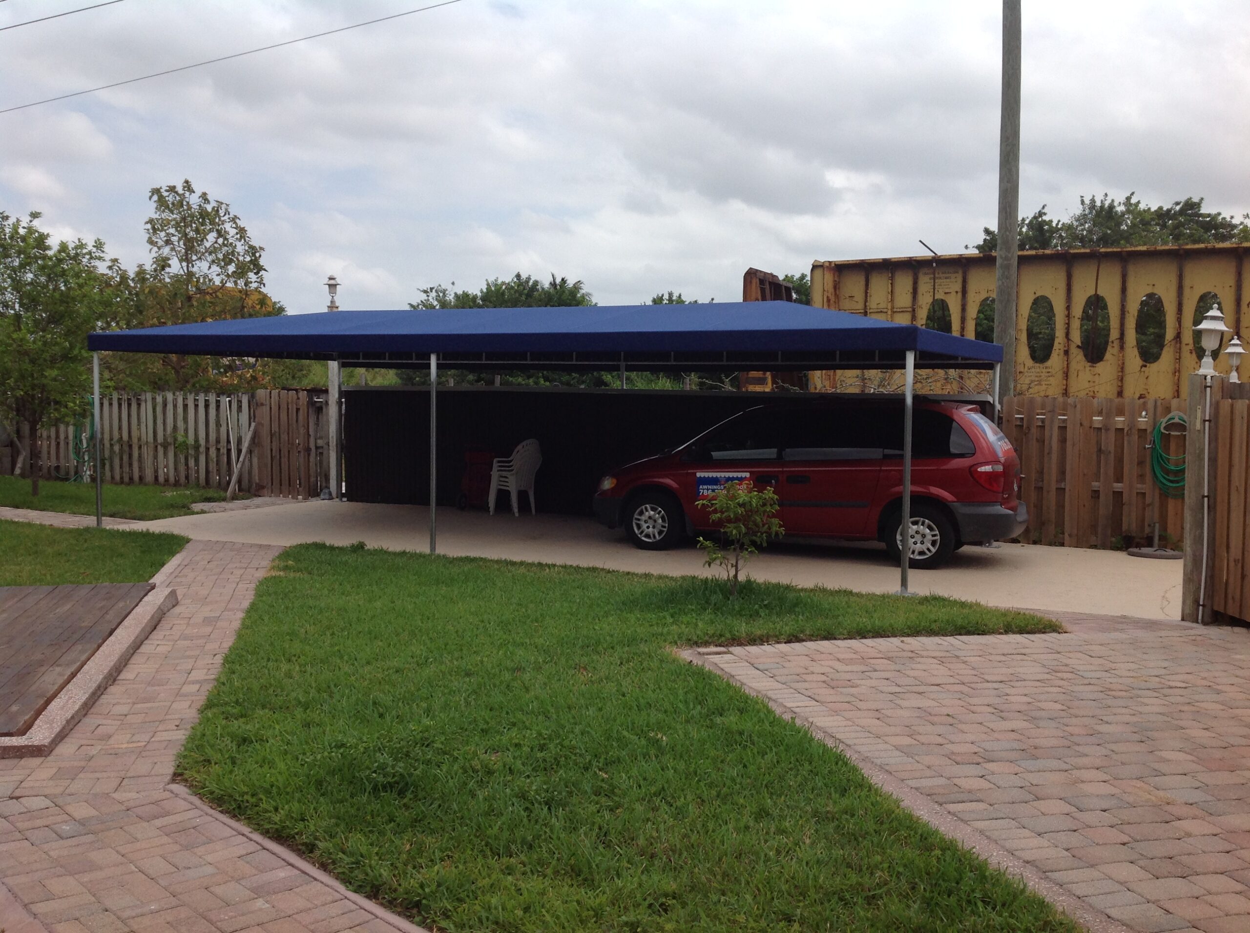 Residential carport providing coverage for two vehicles