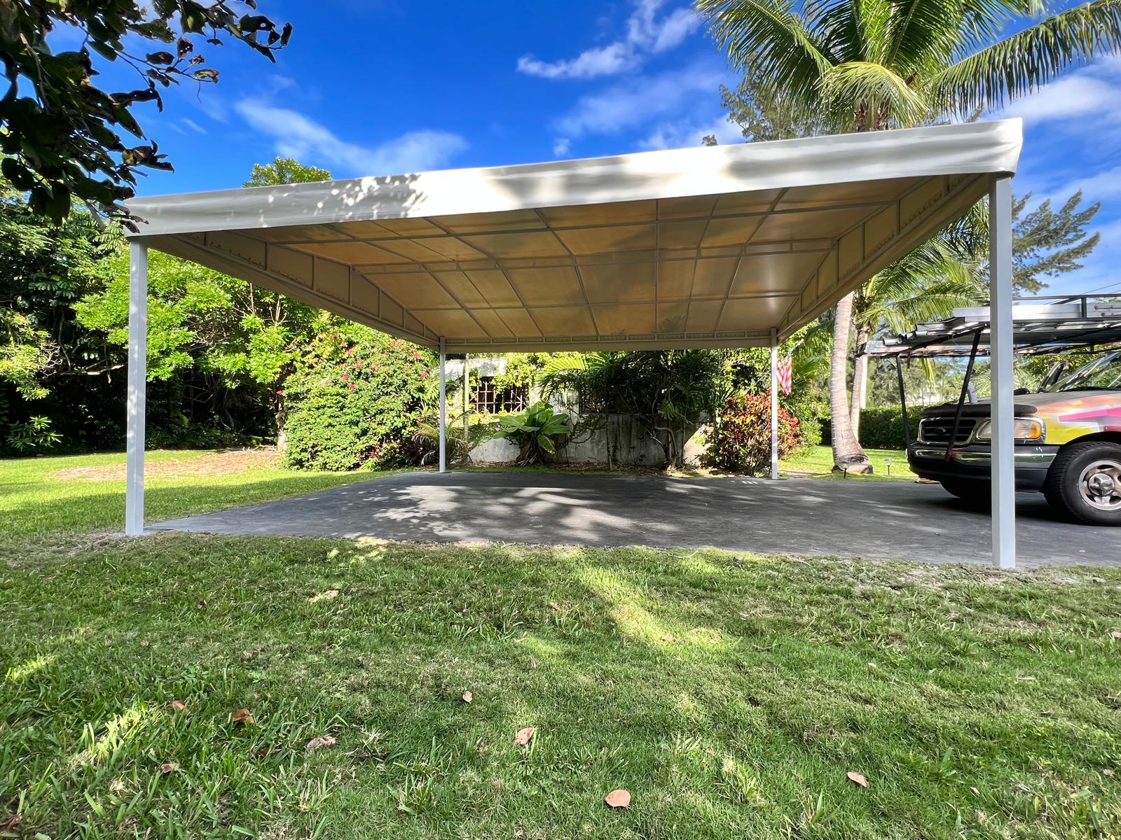Large beige carport providing wide vehicle coverage