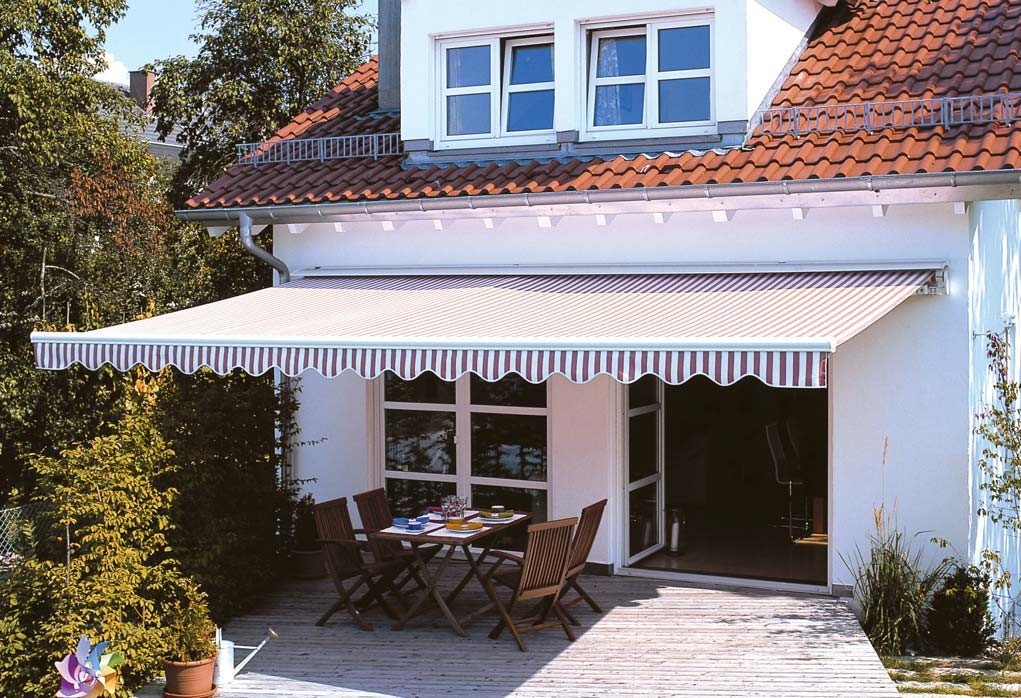 Universal retractable fabric awning extended above a residential deck